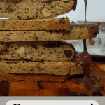 Stack of espresso and hazelnut biscotti with chocolate sauce dripping onto the biscotti