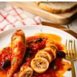 Stuffed Squid in tomato sauce on a plate, one whole and one sliced.