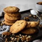 Coconut Pecan Cookies piled up onto a baking sheet.