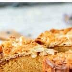 image with text. text reads "buttery almond swedish tosca cake". image is slice of cake with almond topping cut from whole cake viewed side on.