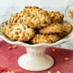 Pignoli Cookies on a white plate with a stand.