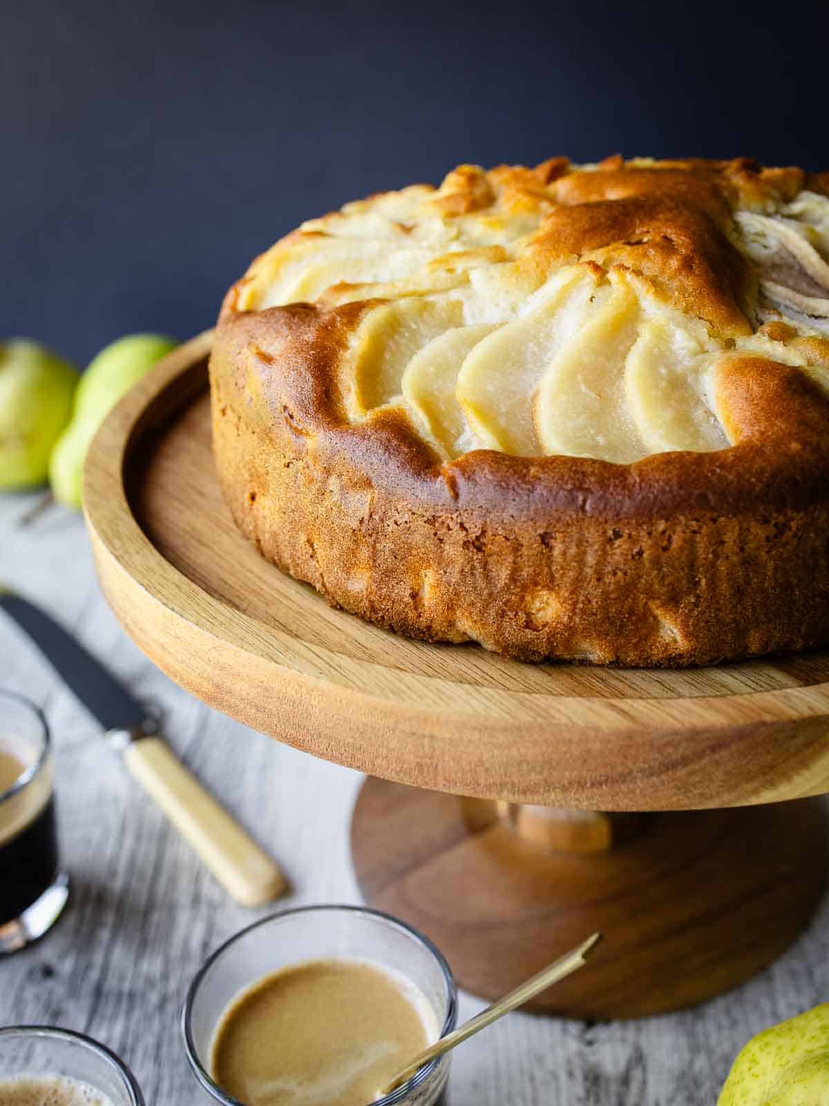 Italian Pear Cake on a wooden cake stand.