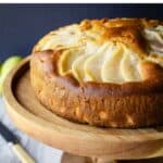 Italian Pear Cake on a wooden cake stand.
