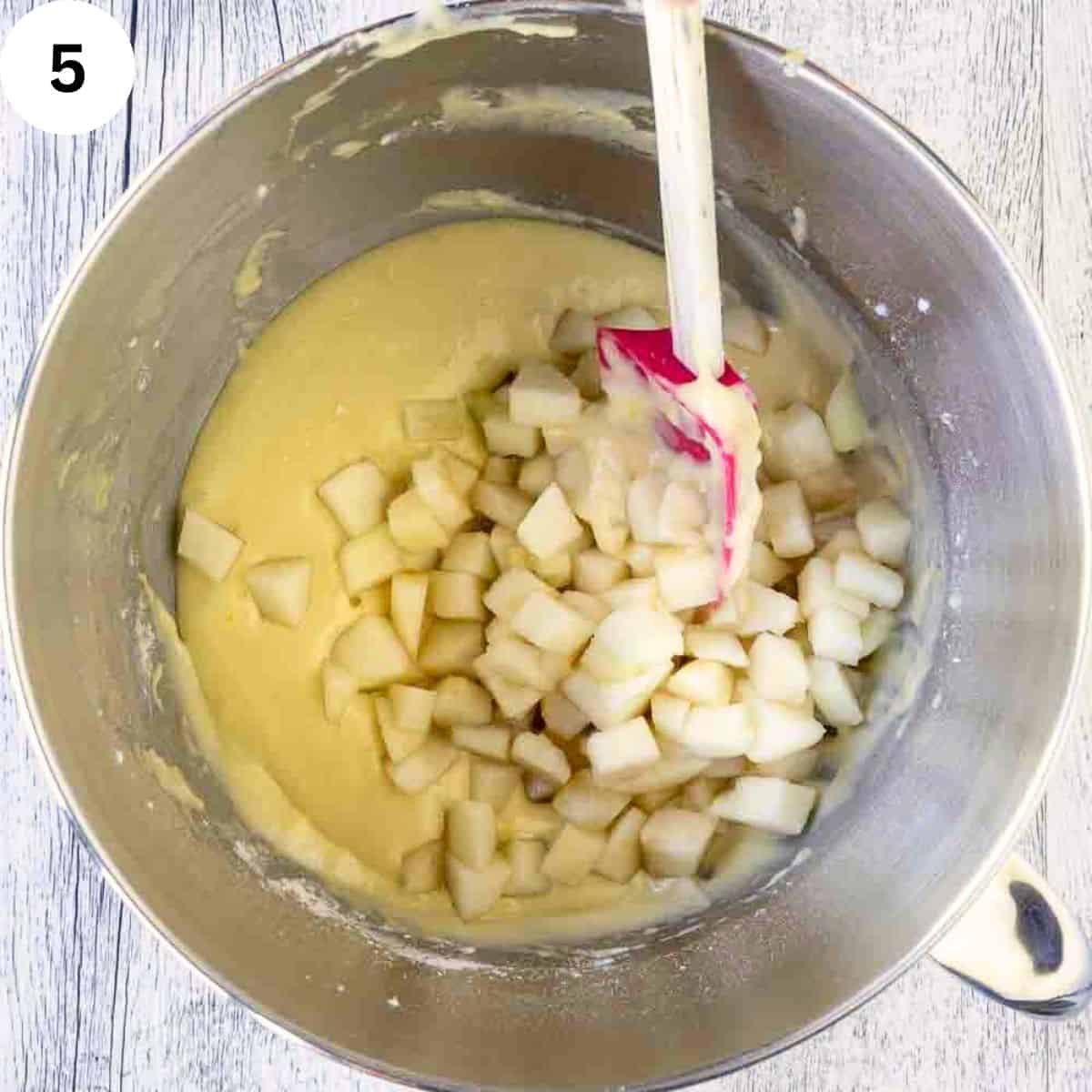 Adding diced pears to yellow batter.