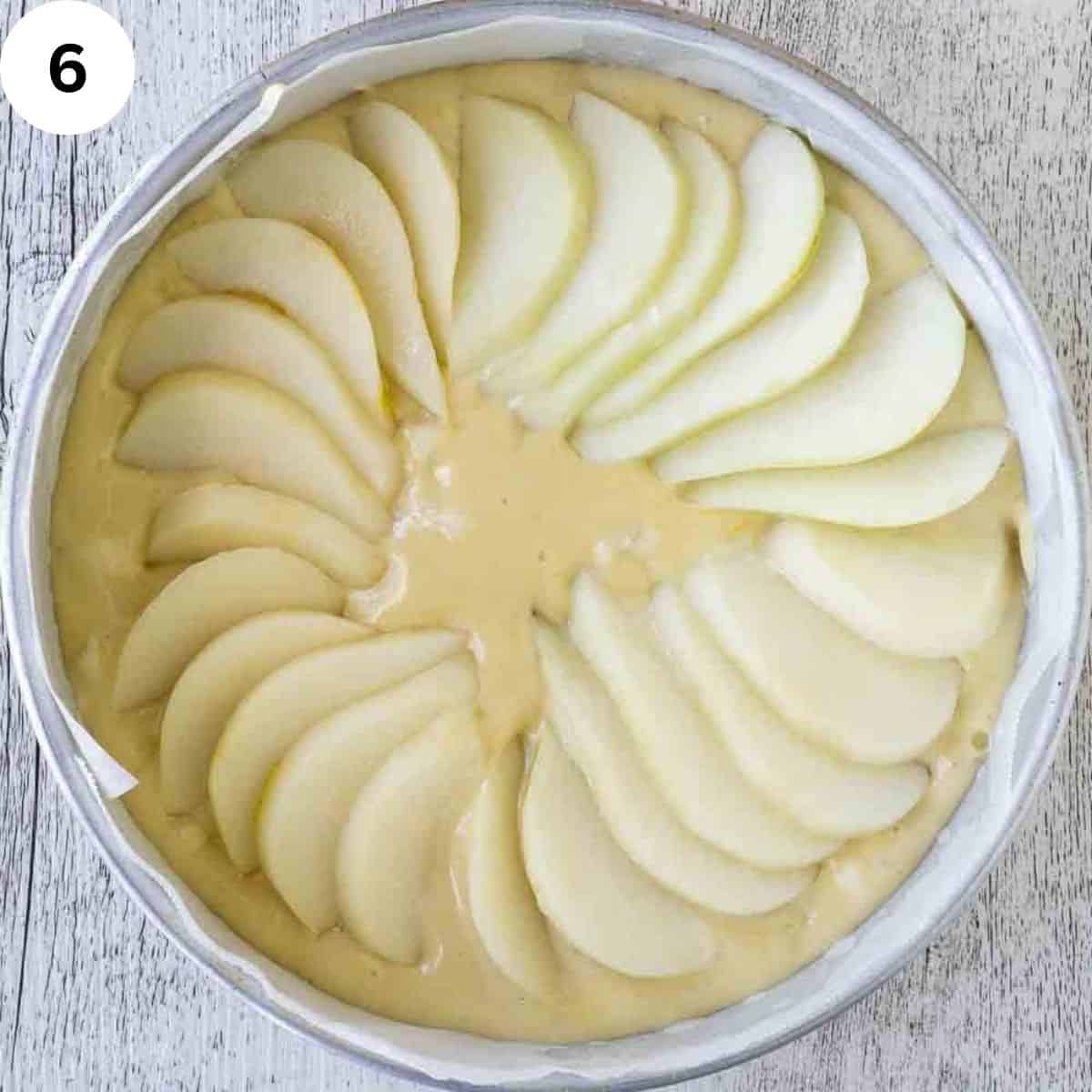 Pear slices in a concentric circle on top of cake batter.