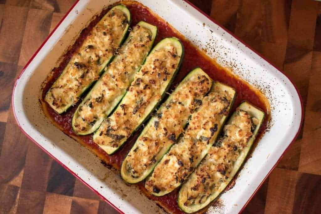 Baking tray with six Stuffed Zucchini with Ricotta in tomato sauce.