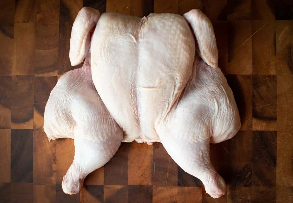 Raw butterflied chicken.