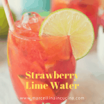 Glass of Strawberry Lime Water with strawberries and second glass behind