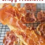Crispy Prosciutto held by two fingers.