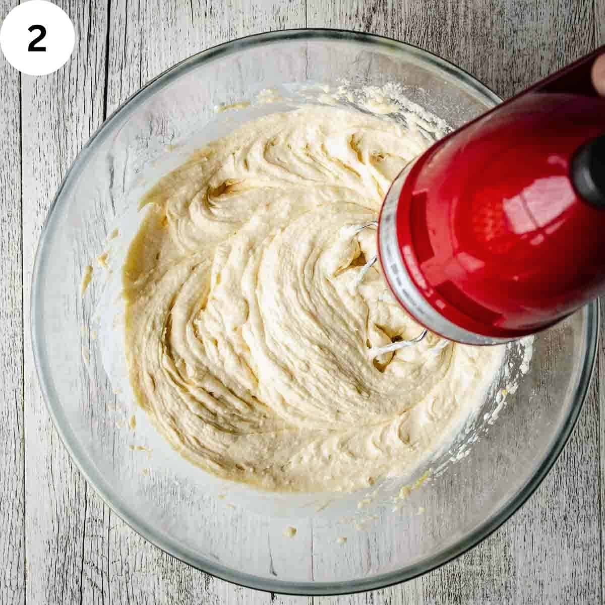 Hand held electric mixer combining cake batter.