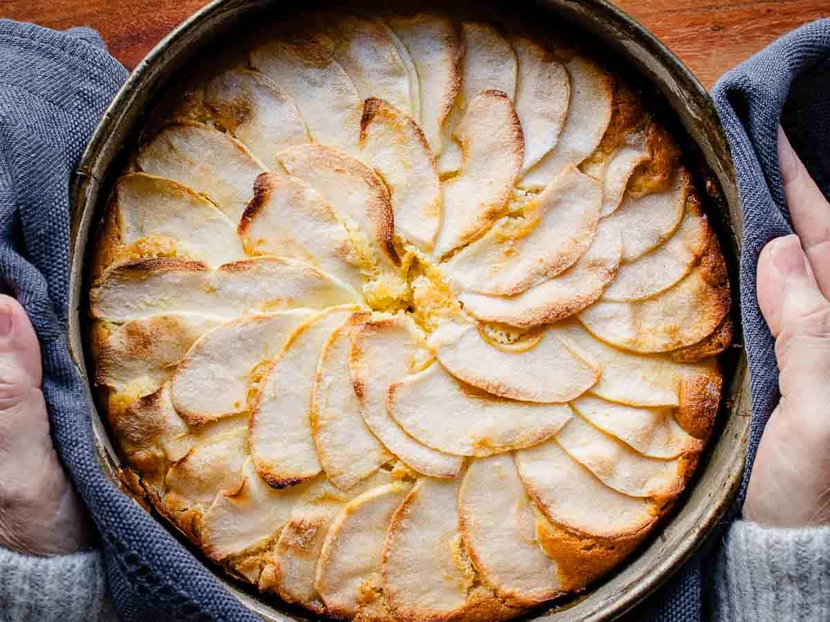 Moist Apple cake flavored with vanilla and lemon #applecake #cake #recipes #italianfood Overhead view of a baked cake topped with apple slices.