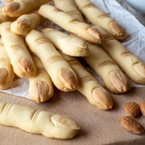Witches Fingers cookies piled onto a wooden board.