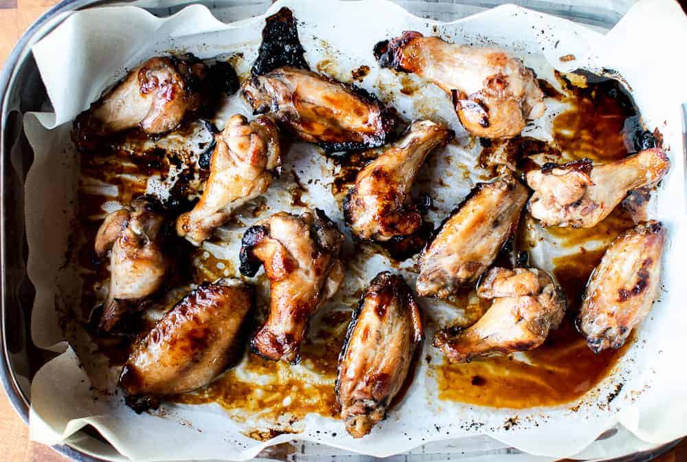 Honey Baked Chicken Wings are so delicious and easy to prepare. This recipe is a must-have in every cook's repertoire. Simple to prepare and loved by all. This recipe uses a special ingredient which give this sticky chicken wings, the wow factor! Honey baked chicken wings in baking pan lined with paper