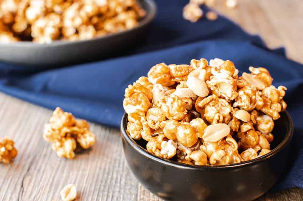 Caramel popcorn with nuts is a delicious and easy snack which everyone loves! #caramelcorn #bestcaramelcorn #caramelcornwithnuts #caramelpopcorn Finished caramel popcorn recipe served in bowls.