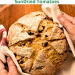 Italian Quick Bread wrapped in a cloth held by two hands.