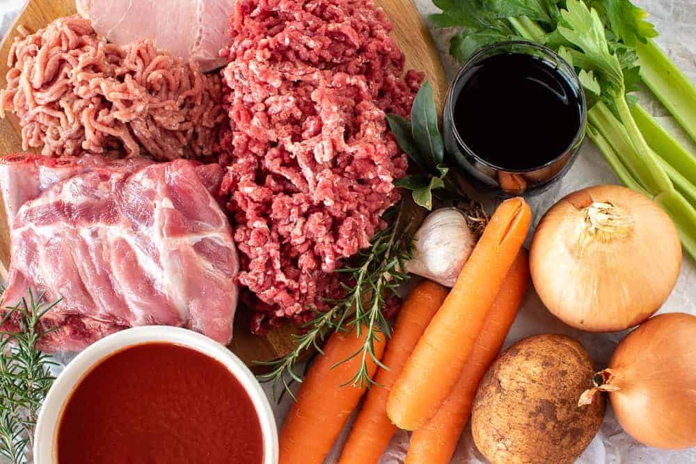 This Ragù Pasta Sauce has my father's secret ingredient that makes all the difference. This recipe makes a big batch so that you have lots to freeze for later. #ragu #pastasauce #italian #recipe ingredients as in the recipe card laid out and viewed from above.