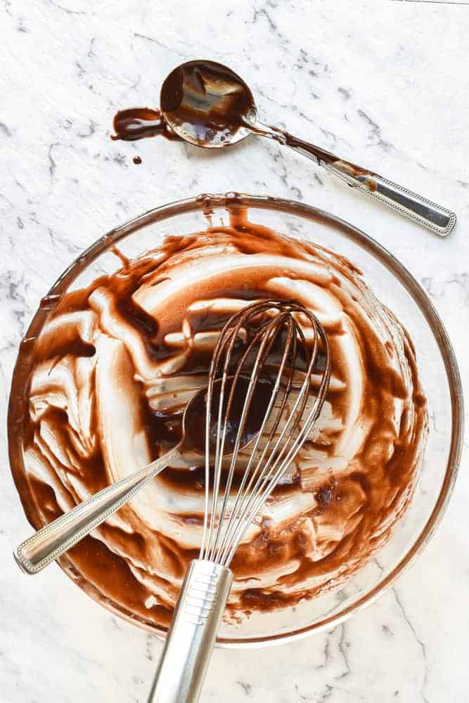 An easy Chocolate Pudding Recipe that is so rich, gooey and decadent! These puddings a super quick to make. #chocolatepuddingrecipe #chocolatepudding #chocohotopots #nigellasrecipes #chocolatedessert Scraped bowl, whisk and spoons after preparing chocolate pudding recipe viewed from above