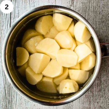 Peeled and cut up potatoes in a saucepan covered with water.