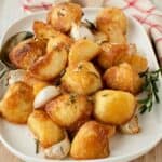 Roasted Garlic and Rosemary Potatoes on a white oblong platter.