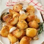 Roasted Garlic and Rosemary Potatoes on a white oblong platter.
