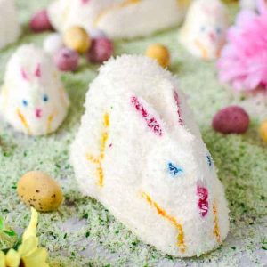 white marshmallow bunnies on green coconut grass.