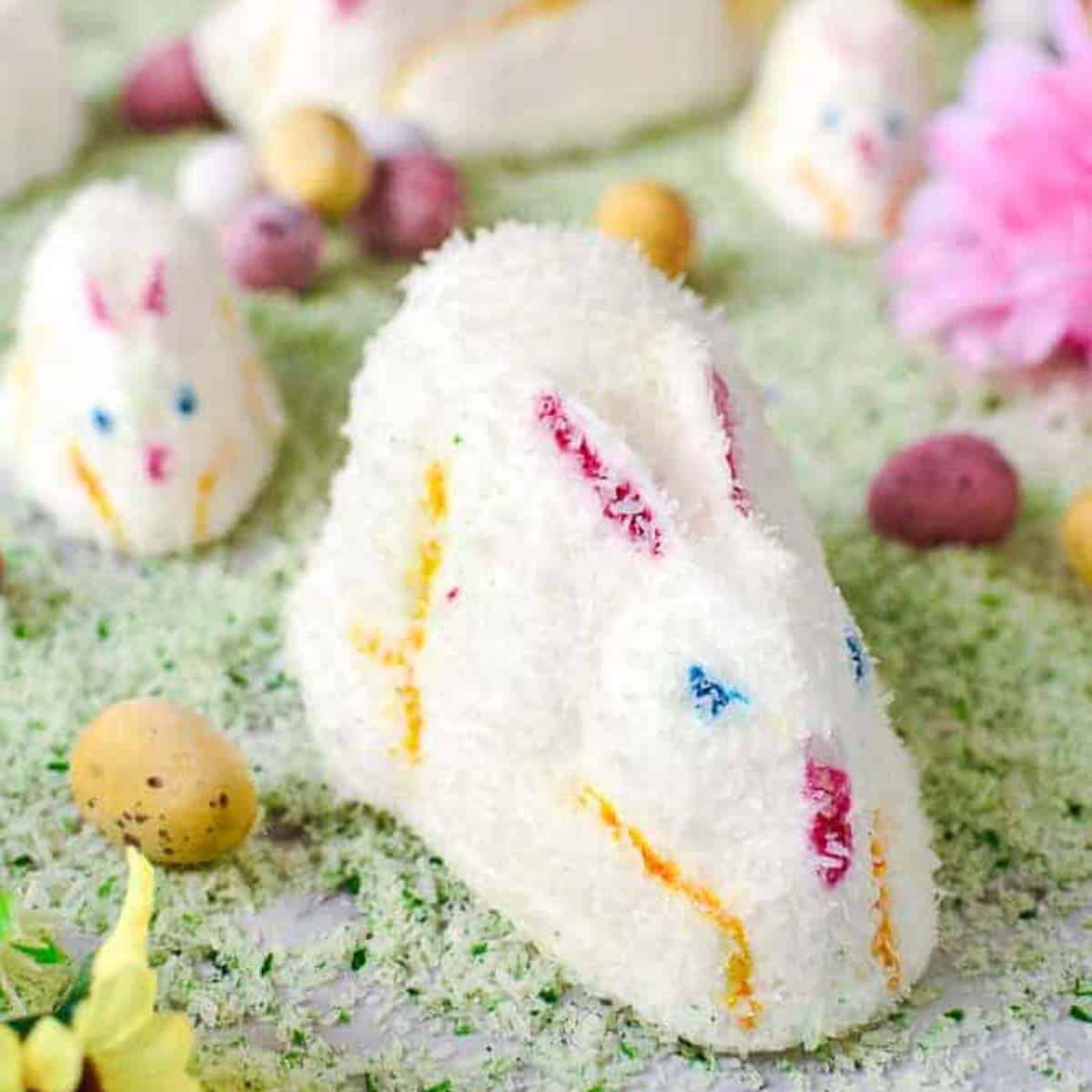 white marshmallow bunnies on green coconut grass.