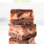 Three chocolate cherry slices stacked one on top of the other on a white plate viewed front on