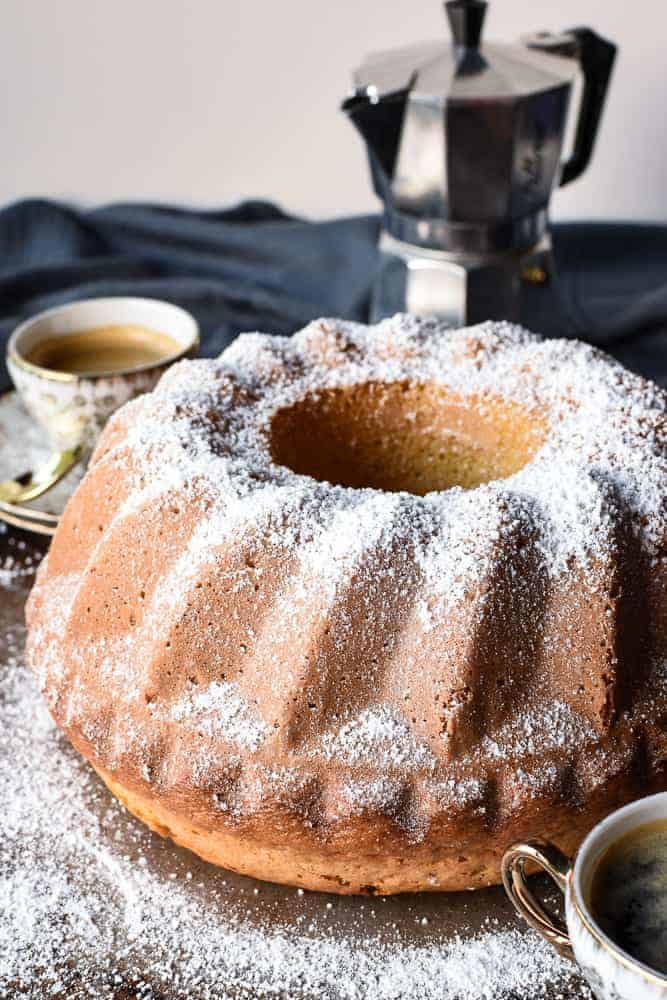 This Lemon Yogurt cake is a traditional Italian breakfast cake. Simple to make and perfect with your morning coffee. #yogurtcake #lemoncake #cakerecipe #italiancake #italianrecipe #baking Bundt cake with two espresso cups of coffee and moka pot.