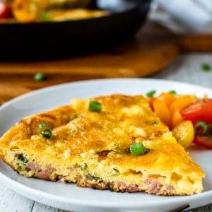 Wedge of frittata on a white plate.