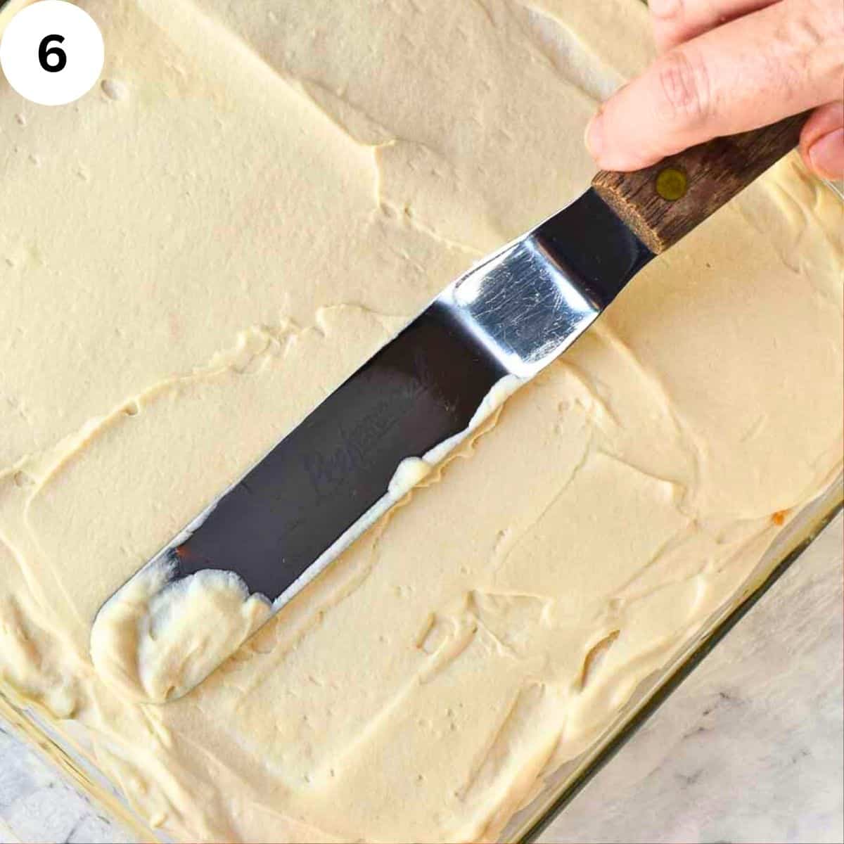 Smoothing the creamy top of tiramisu.
