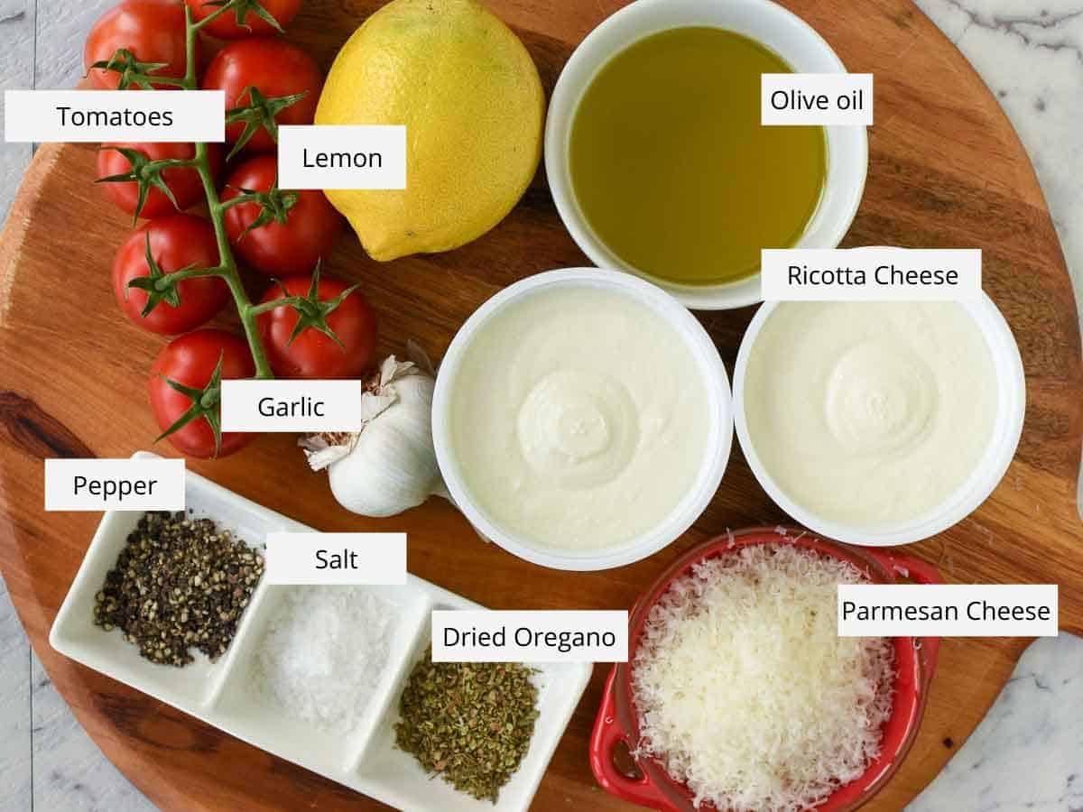 30 minutes. Serves 8. This Creamy Baked Ricotta Dip is full of lemon and garlic flavours. Serve with Roasted Tomatoes and crusty bread for a delicious, savory appetizer. cherry tomatoes, lemon, olive oil, ricotta cheese, grated parmesan cheese, dried herbs, salt pepper garlic viewed from above