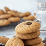 Coffee cookies stacked with one cookie leaning on the stack.