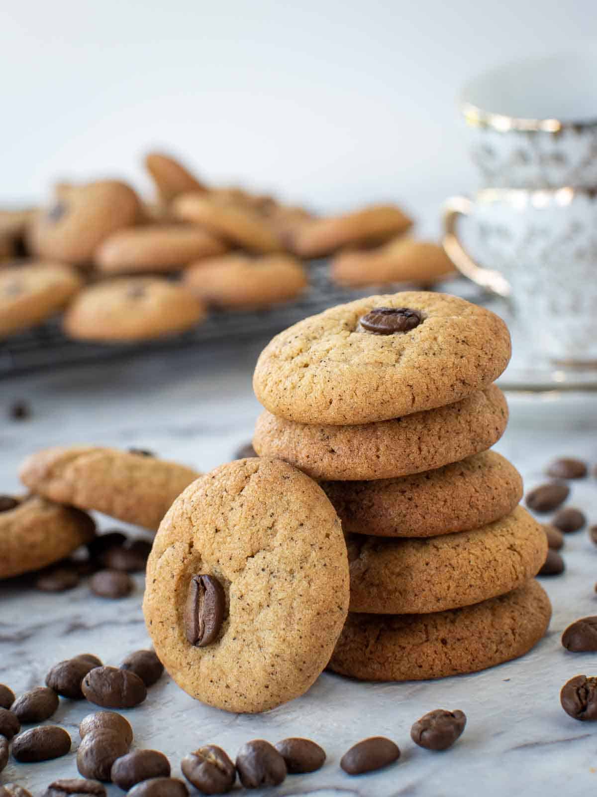 Coffee cookies stacked with one cookie leaning on the stack.