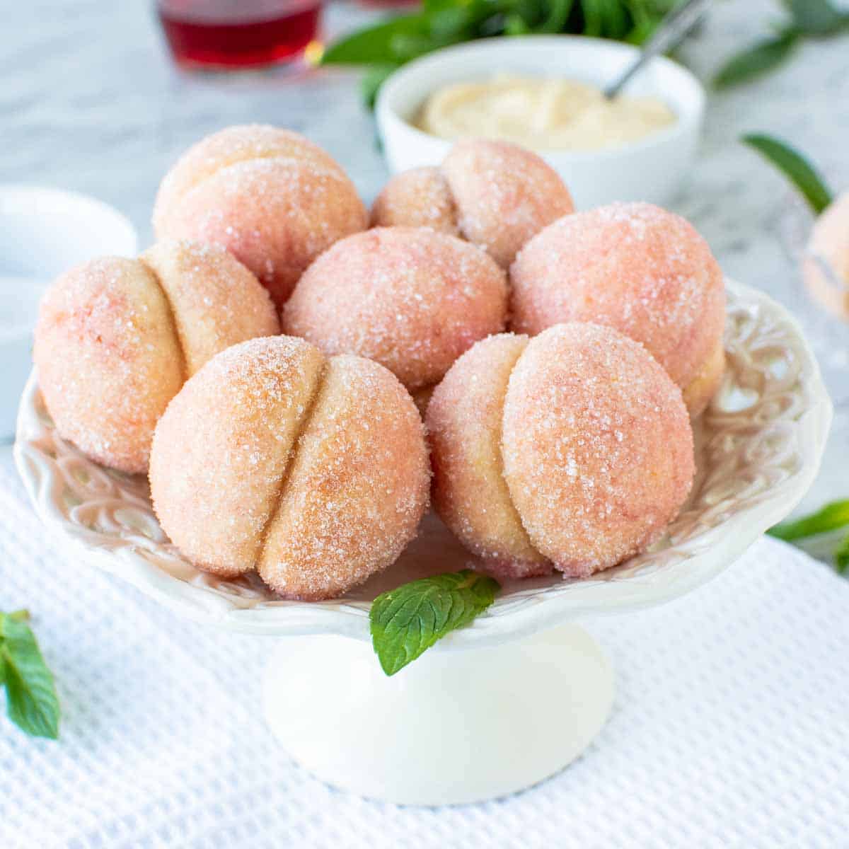 seven Italian Peach Cookies on a white cake plate
