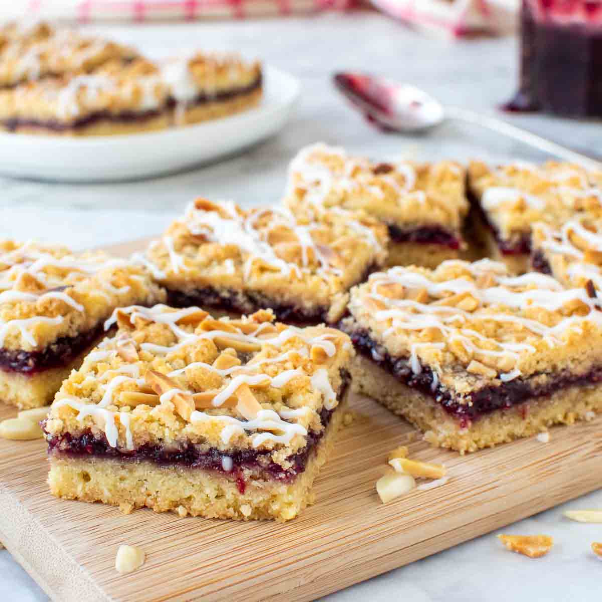 Close up of Raspberry Shortbread Bars on a wooden board.