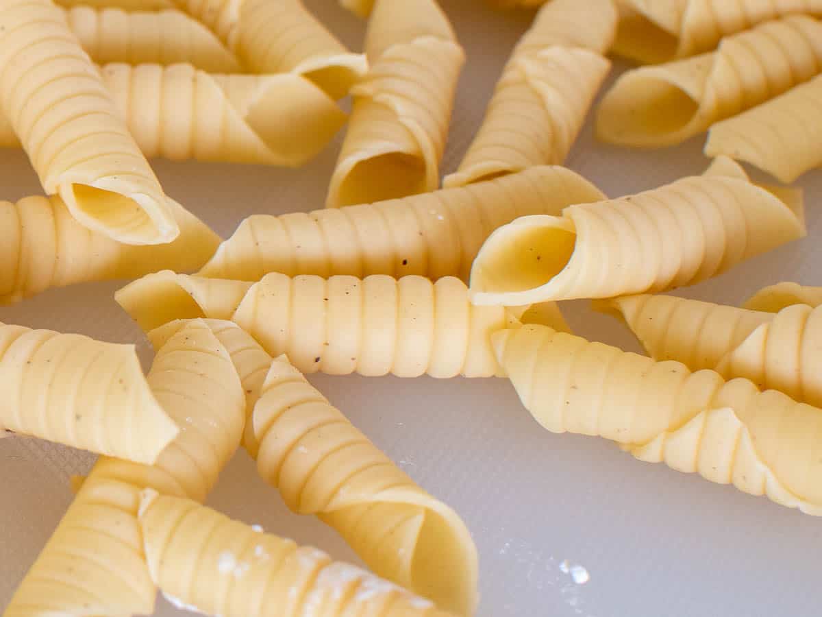 Close up of tubular, handmade pasta with ridges.