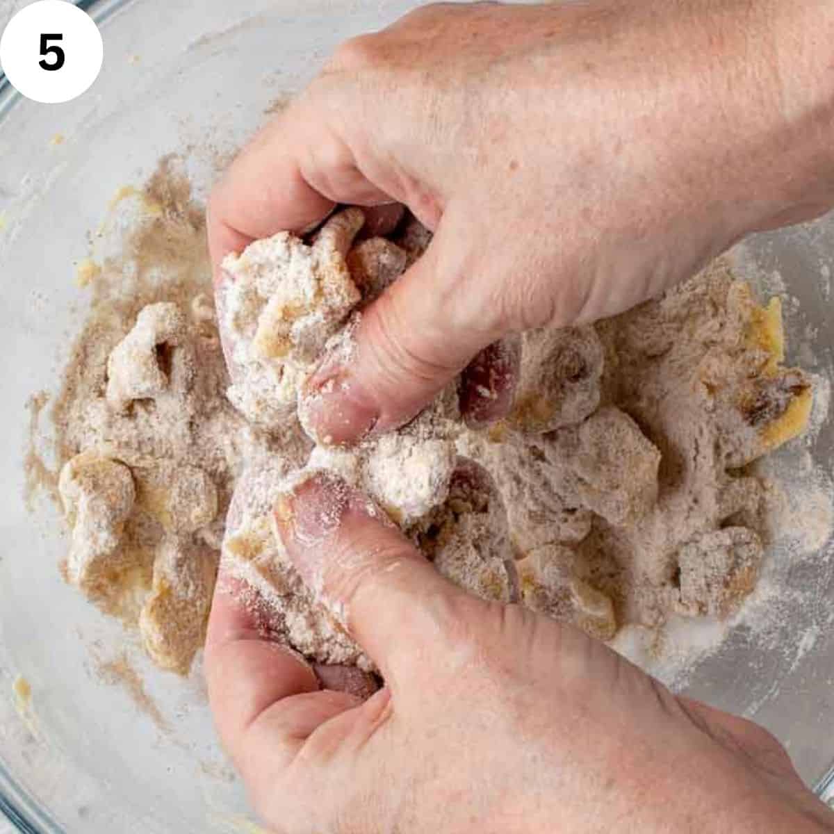 Rubbing flour and butter together with fingertips.