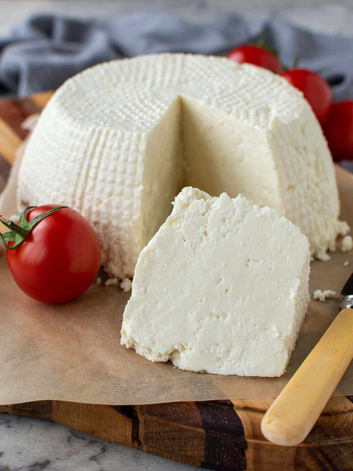 Ricotta cheese on a wooden board for a post answering the question, "can you freeze ricotta cheese".