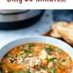 image with text. text reads "Instant pot bean soup only 30 minutes". image is instant pot cannellini bean soup in a pale blue bowl on wooden board.