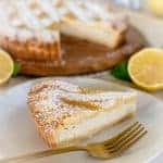 slice of pie on white plate with gold fork and whole pie in the background.