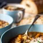Blue bowl filled with brown soup.
