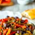 White plate of multi colored strips of fried bell peppers.