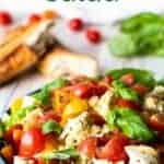 Shallow bowl of tomato, basil and mozzarella salad.