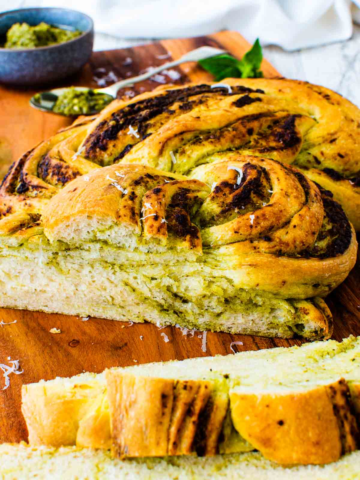 Pesto bread that has been braided and sliced.