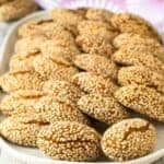 Italian Sesame Cookies arranged on a white plate.