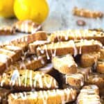 A pile of Lemon Biscotti drizzled with lemon icing.