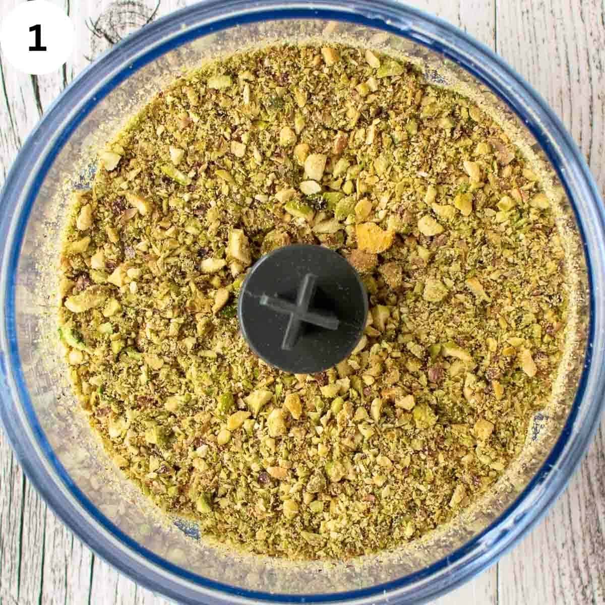 Pistachio nuts finely chopped in a food processor.