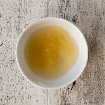 Yellowish jelled substance in a small white bowl.