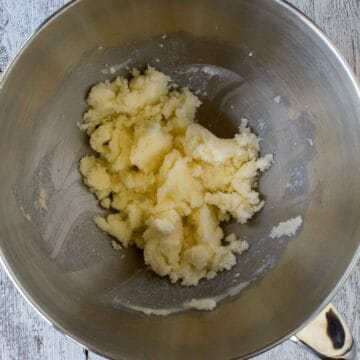 Yellow buttery and creamy mixture in stainless steel bowl.