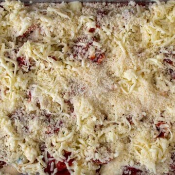 Heavy layer of grated mozzarella and parmesan cheeses over pasta shells.